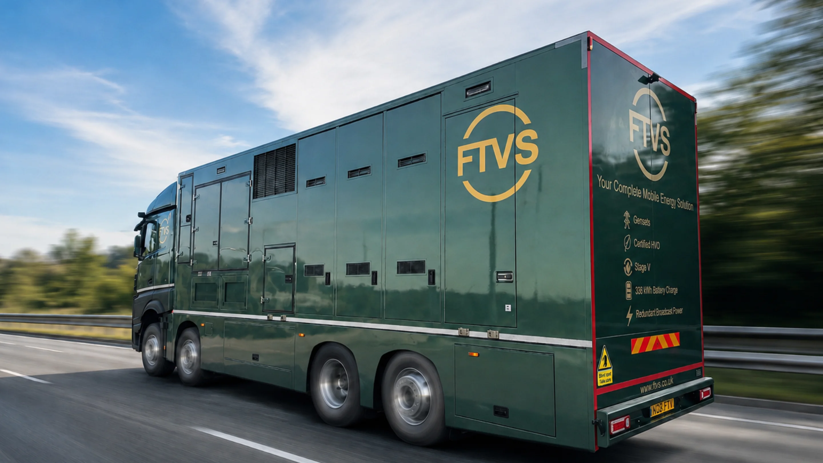 A large generator truck on the move on a british road
